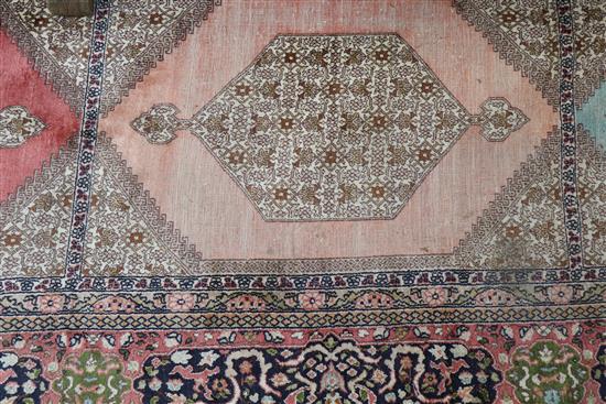 A Persian pattern rose ground cotton and silk rug 298 x 215cm